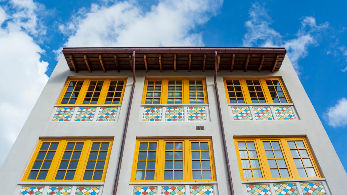 looking up to the sky above a colorful building 