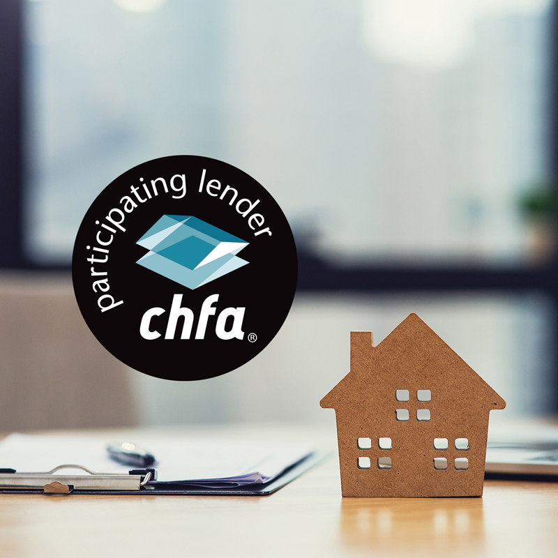 A small wooden cutout of a house with a logo that says chfa participating lender