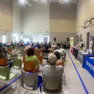 People sitting in a room listening to a speaker