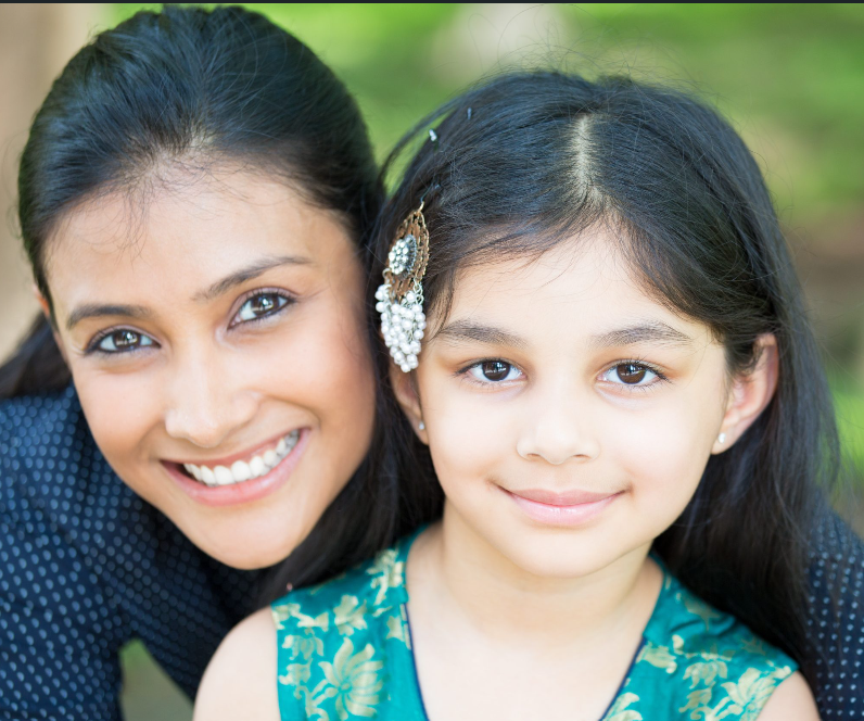 Adult woman smiling with child