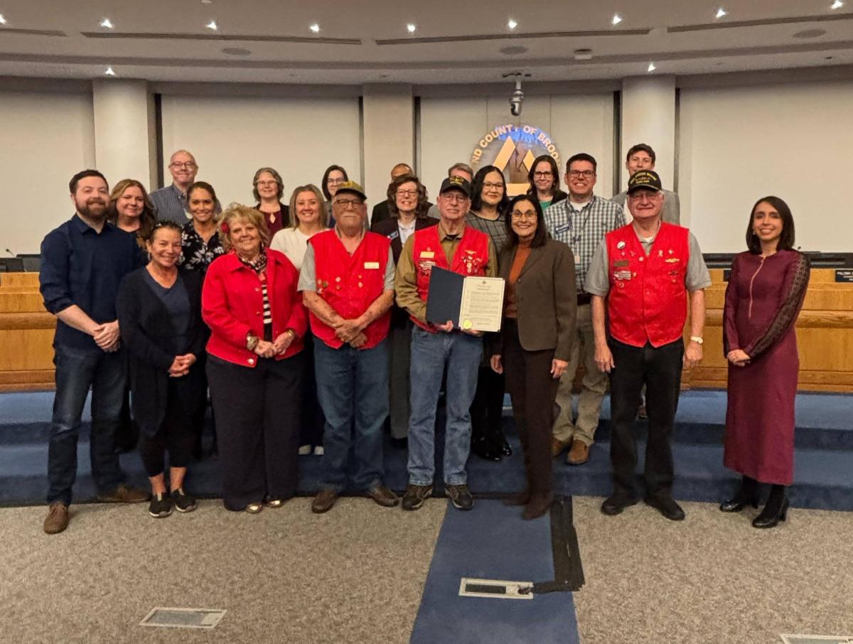 A group of people pose for a picture in council chambers