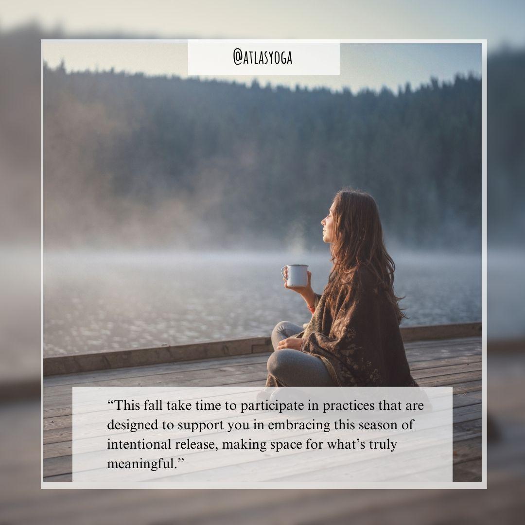 a female with brown hair_brown top_grey pants sitting cross legged_overlooking the water_drinking a hot cup of tea