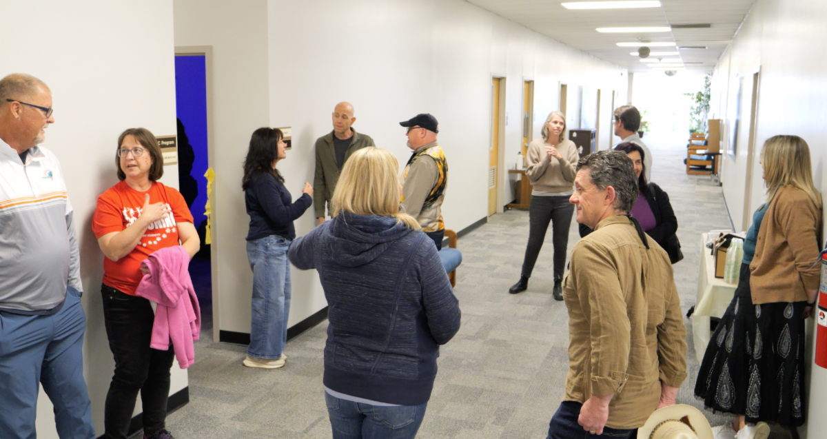people gathered in a hallway around the new NAU sensory room