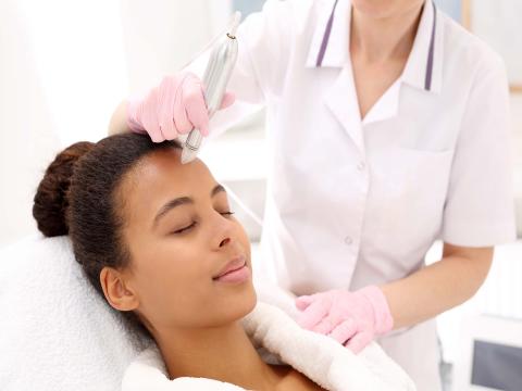 Woman undergoing microneedling treatment