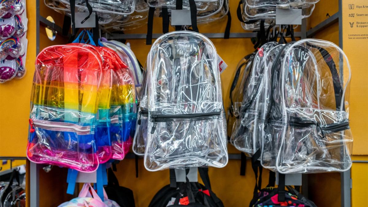 Clear backpacks hanging on retail rack
