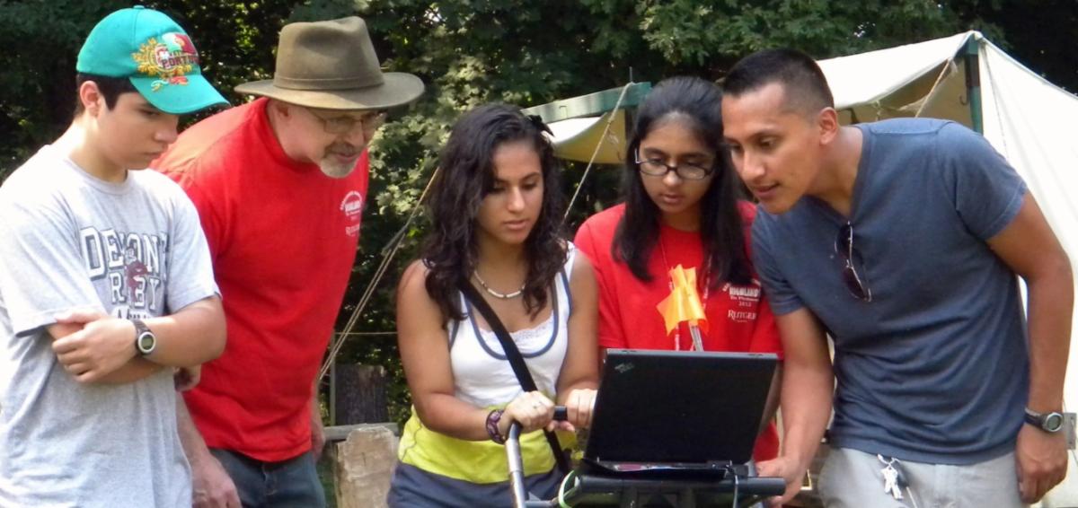 Alec Gates with students doing field work