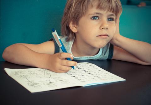 Child looking stressed at desk