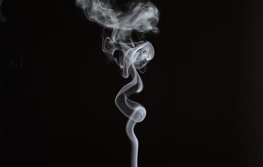 Cigarette smoke against black background