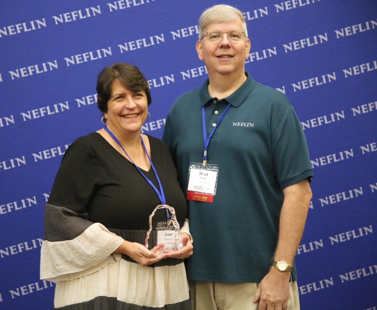 Photograph of NEFLIN member Jenny Ransone accepting the Member of the Year award from NEFLIN director Brad Ward