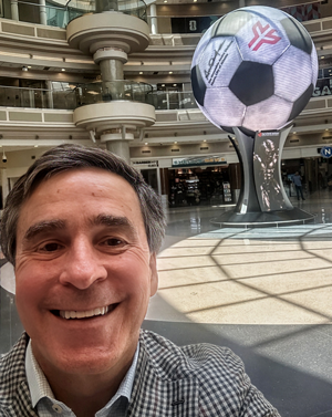 Charlie Crawford in front of World Cup statue