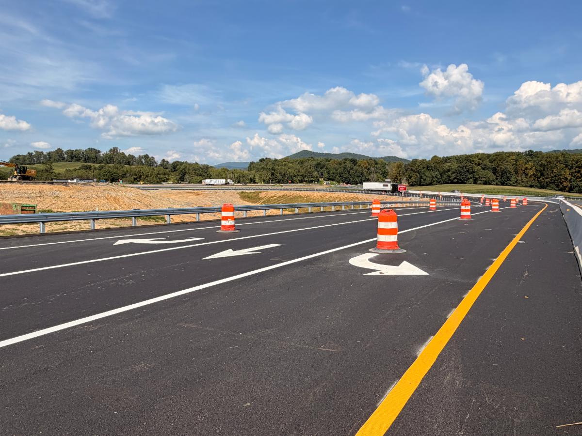 Newly paved and marked on-ramp with construction barrels