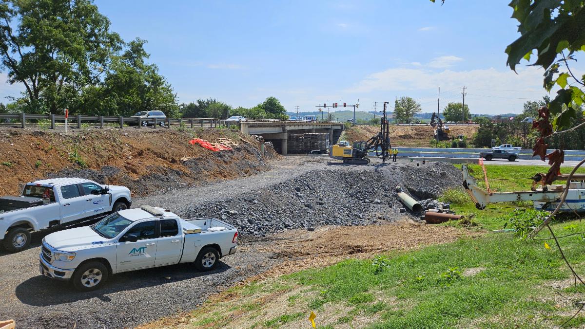 Construction trucks and equipment at work at overpass for Pleasant Valley Road