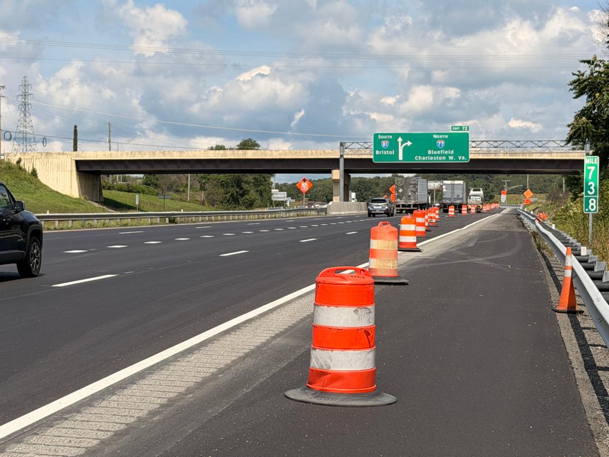 Newly paved auxiliary lane with construction barrels
