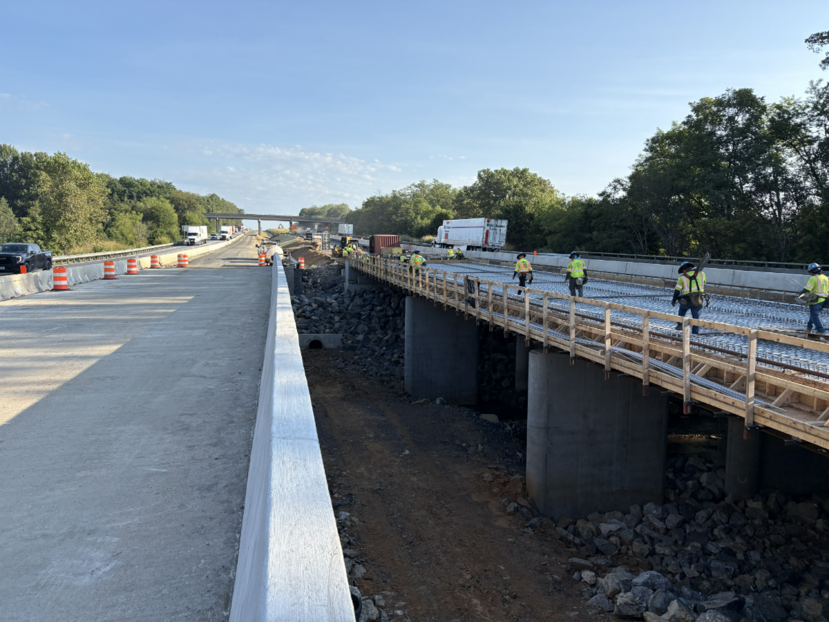 Construction workers in PPE work on bridge on I-81