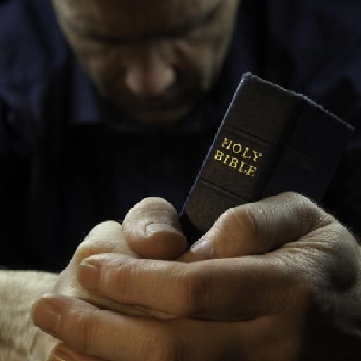 man_praying_holding_bible.jpg