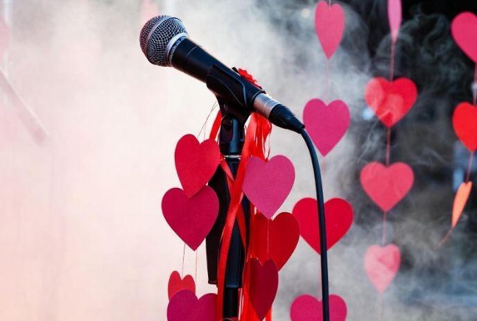 a microphone with handing paper hearts