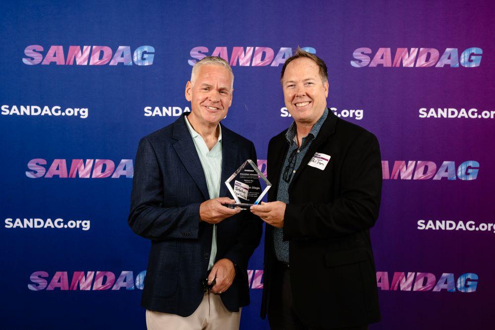 Tait and Phil hold up the SANDAG Diamond Award