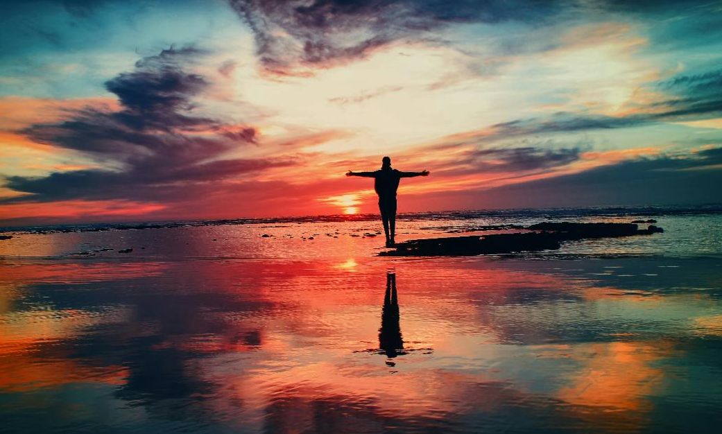 Silhouette of a person on the beach at sunset