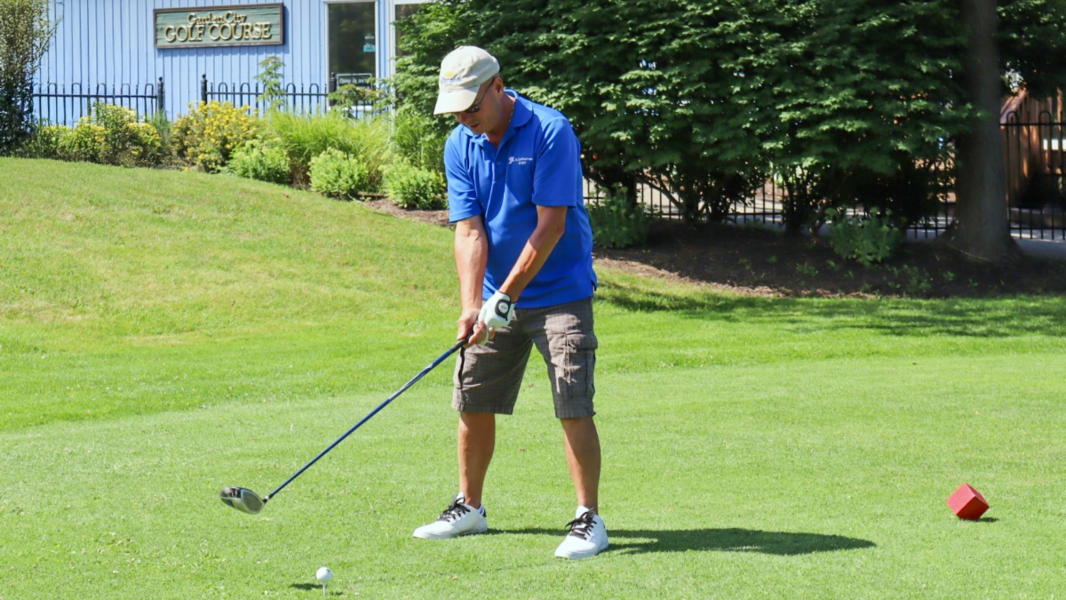 A golfer tees off at Garden City Golf Course.