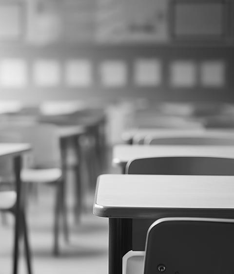 An empty classroom, with two rows of desks.