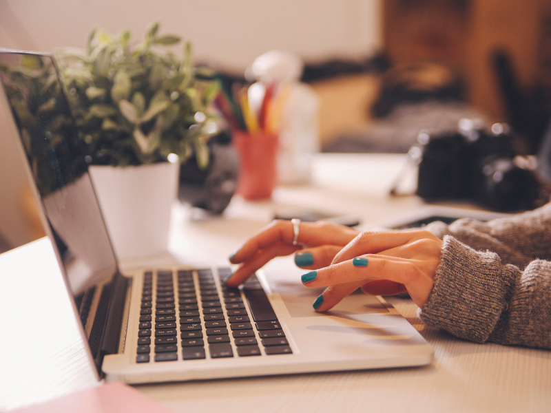 Fingers typing on a computer