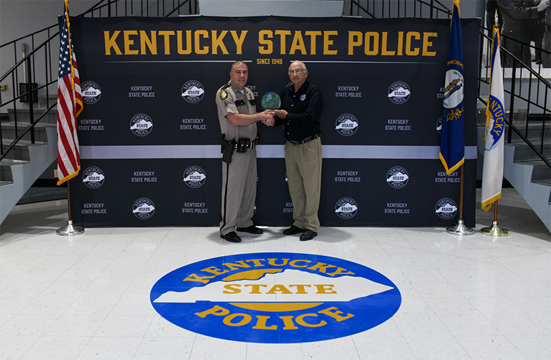 Enforcement Efficiency Award given to the State of Kentucky for calendar year 2022 presented by UCR Board Member William Debord to ​Sargent Doug Stacy, Kentucky State Police Commercial Vehicle Enforcement Division.