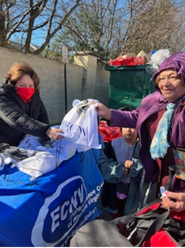[Image: Rosalia Fajardo distributing COVID-19 test kits, energy saving light bulbs, and goody bags].
