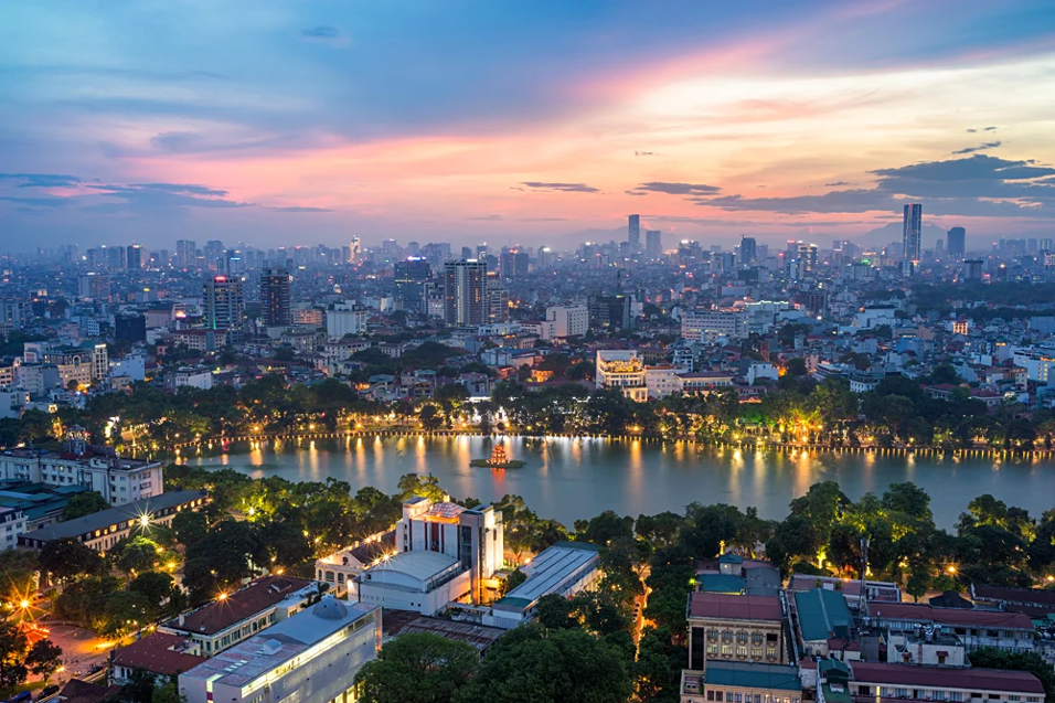 A nighttime view of Hanoi, Vietnam overlooking the river.