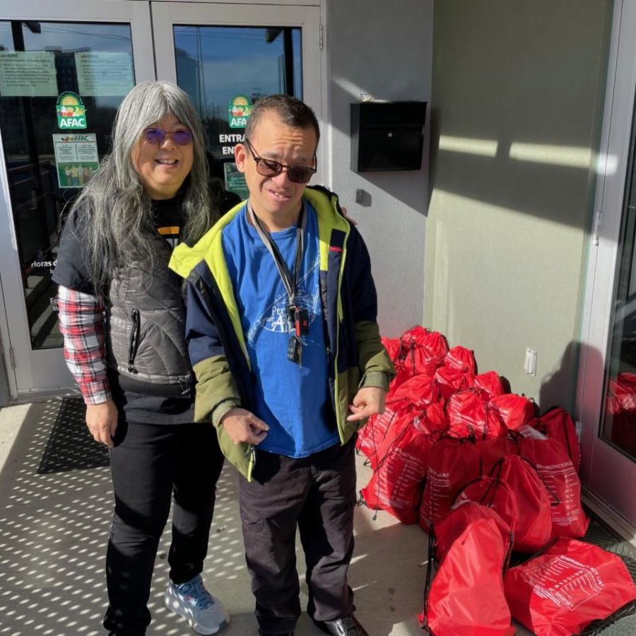 [Image: Cherie and son, Pete, deliver their completed bags to AFAC].