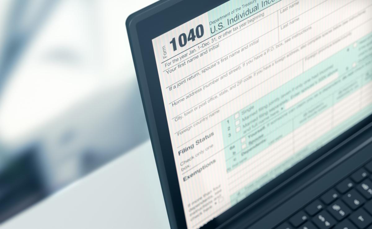 [Image: 1040 Individual Income Tax Return form on a computer screen].