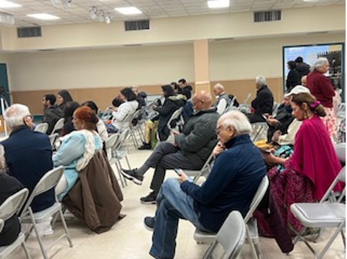 [Image: People gathered at the Durga Temple to find out about opportunities and resources].