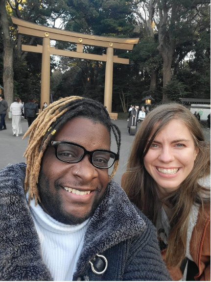 Traveling through Tokyo, these are pictures of various Pokémon including a graffiti of Mewtwo on the wall, and me hugging Snorlax, posing with my friend Erin in front of Temple torii gates and take a picture of the mirrored entrance to a fashion mall. 