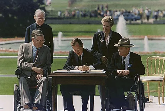 President George H.W. Bush signs ADA Act into Law