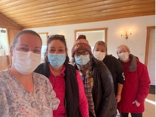 Rosalia Fajardo (second from left) assists Independence Empowerment Center of Prince William in their Covid-19 outreach initiative in Delaplane, Virginia