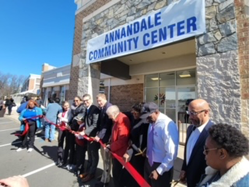 [Image: Rosalia Fajardo (right) in a black coat with a Latino support group of mothers with children with Autism; Members Board of supervisors of Fairfax County at the ribbon cutting for the new Annandale Community Center].
