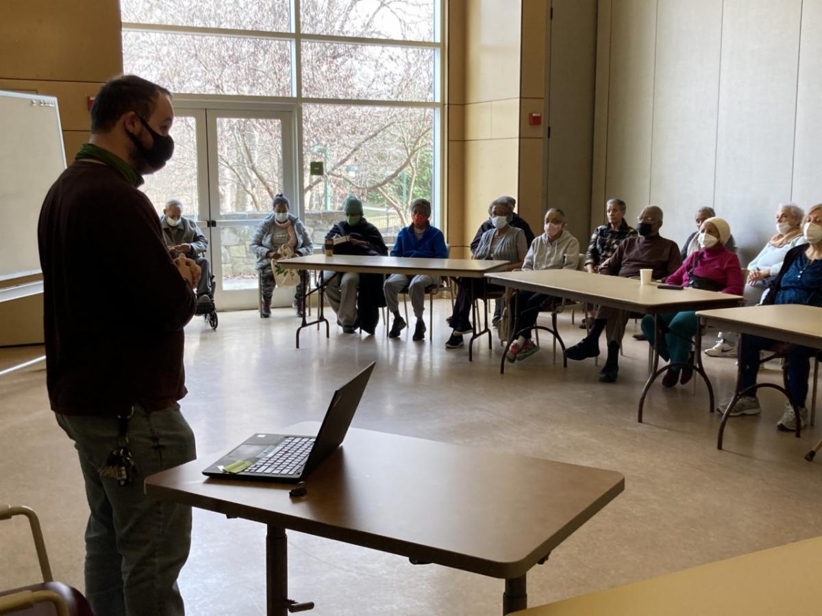 Andrew Shaw presenting to a group of senior citizens about ECNV services at Walter Reed.