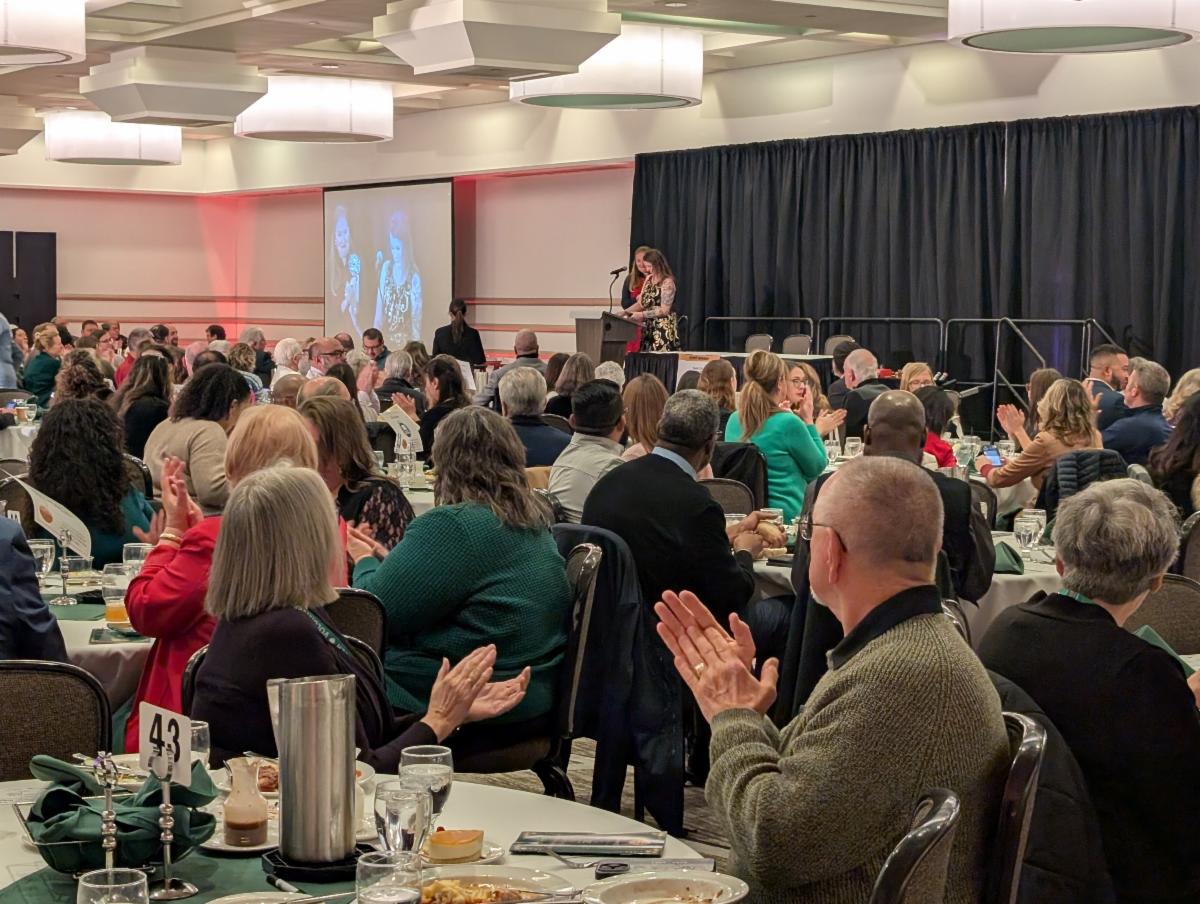 Audience applauding a speaker at the TCOA 40th Annual Dinner and Auction