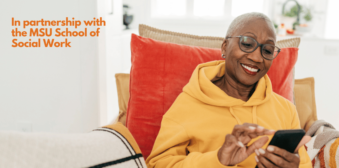 An older woman smiles while on her smartphone. 