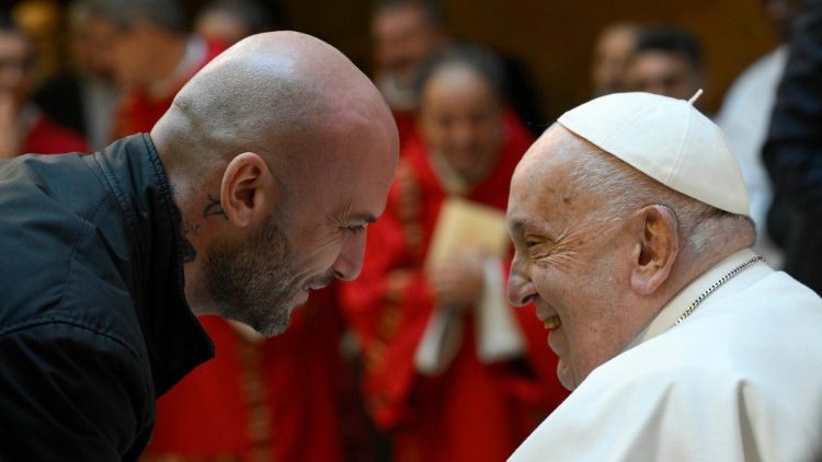 Pope greets a prisoner in the Church of Our Father.