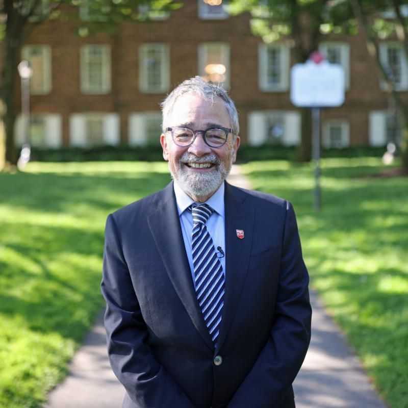 Man standing in front of a building in a suit