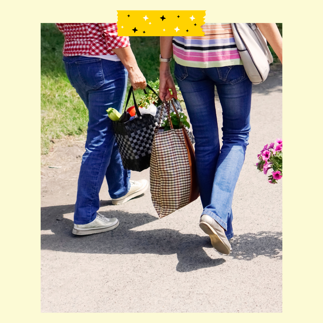 Two people walking with grocery bags 