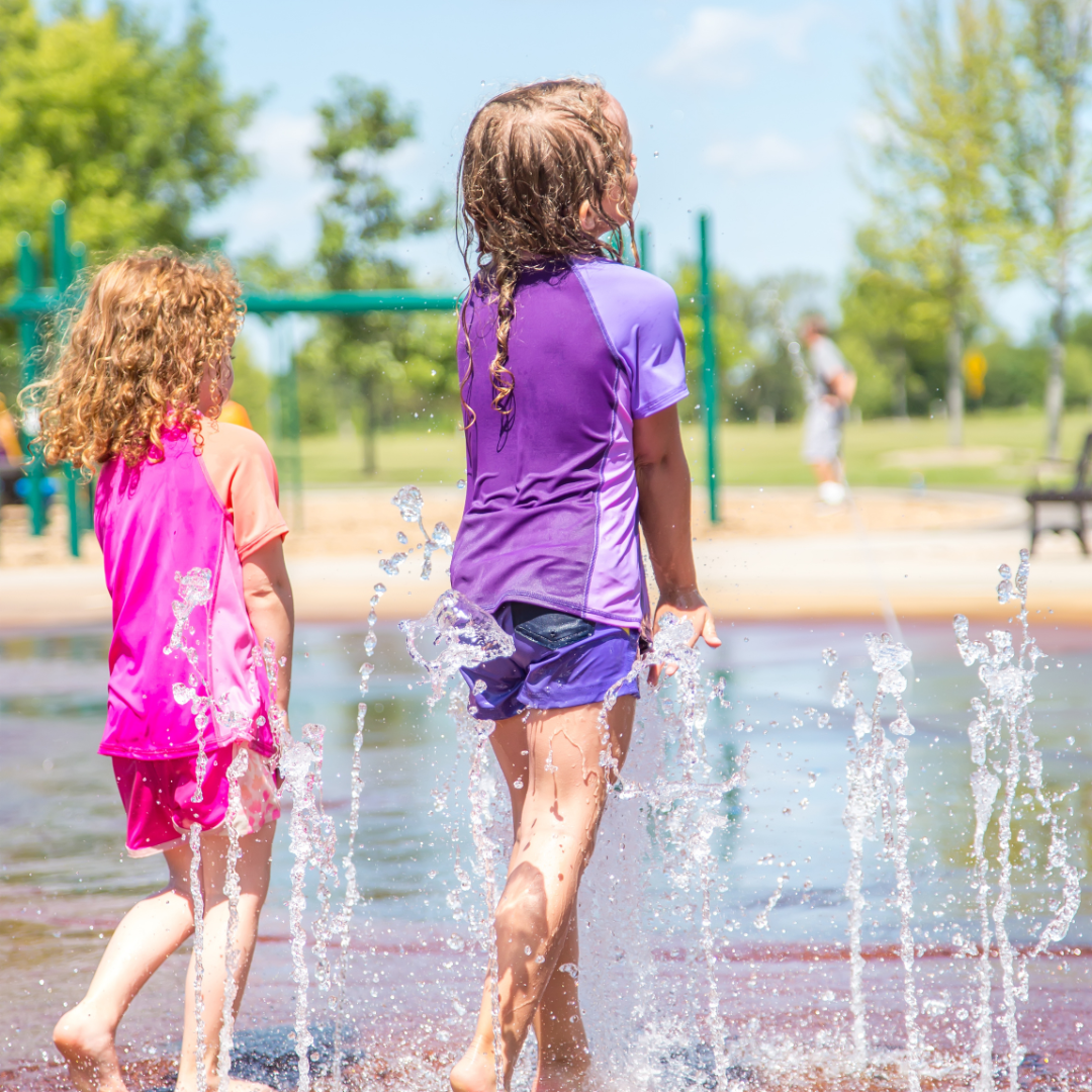 Two kids playing in a splash pad
