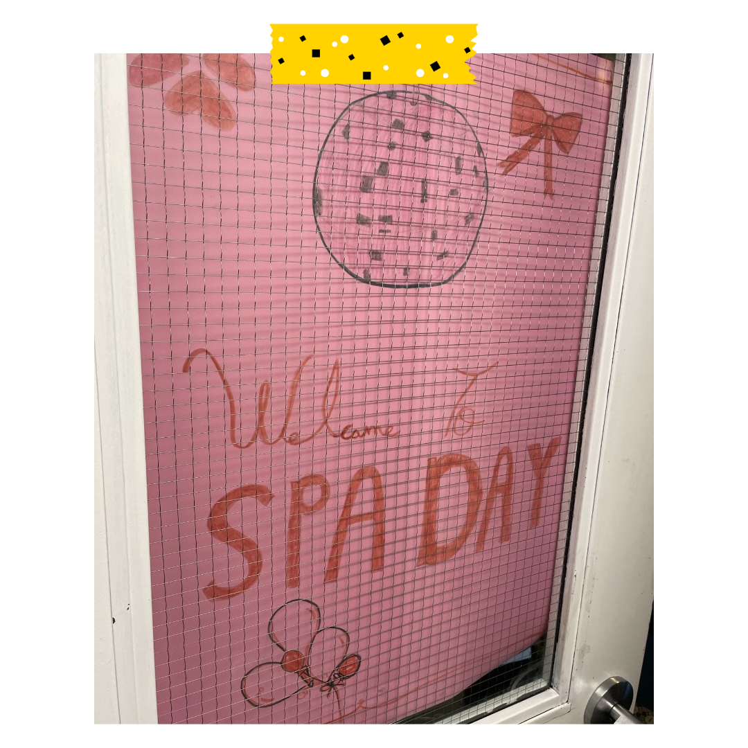 Pink poster that says welcome spa day in marker.