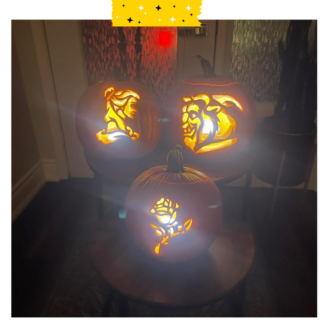 Three pumpkins with carved with designs of the beauty and the beast.