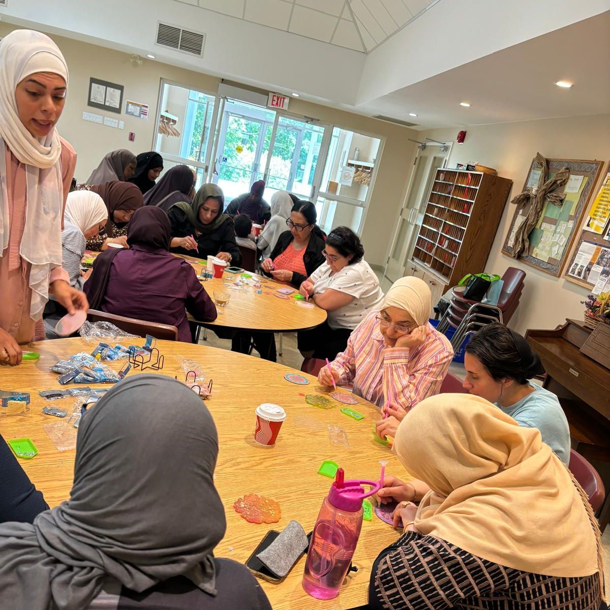 People sitting around a table doing a craft