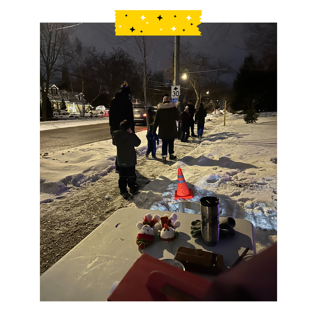 People outside on the sidewalk walking with winter coats on.