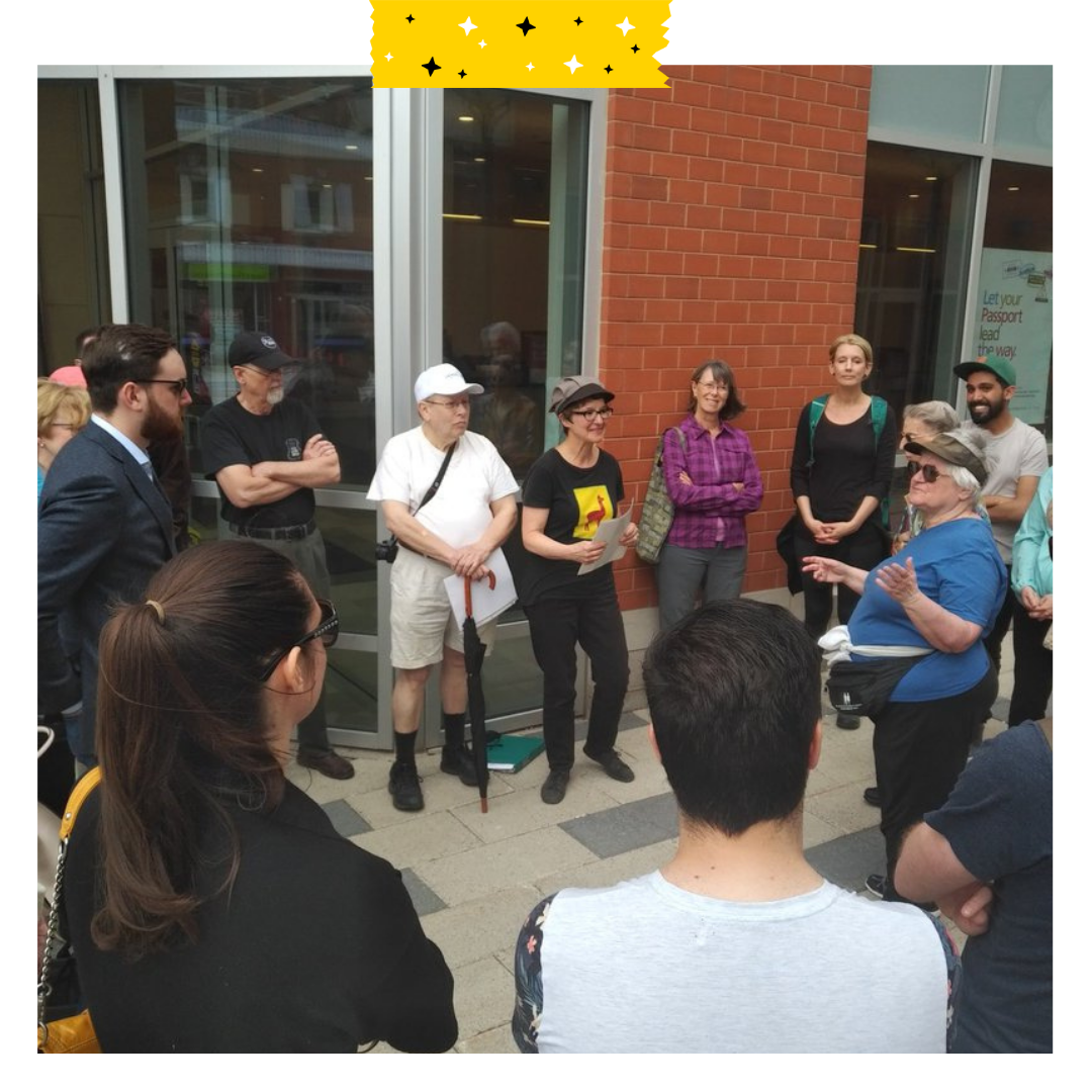 Group of people outside, standing in a circle.