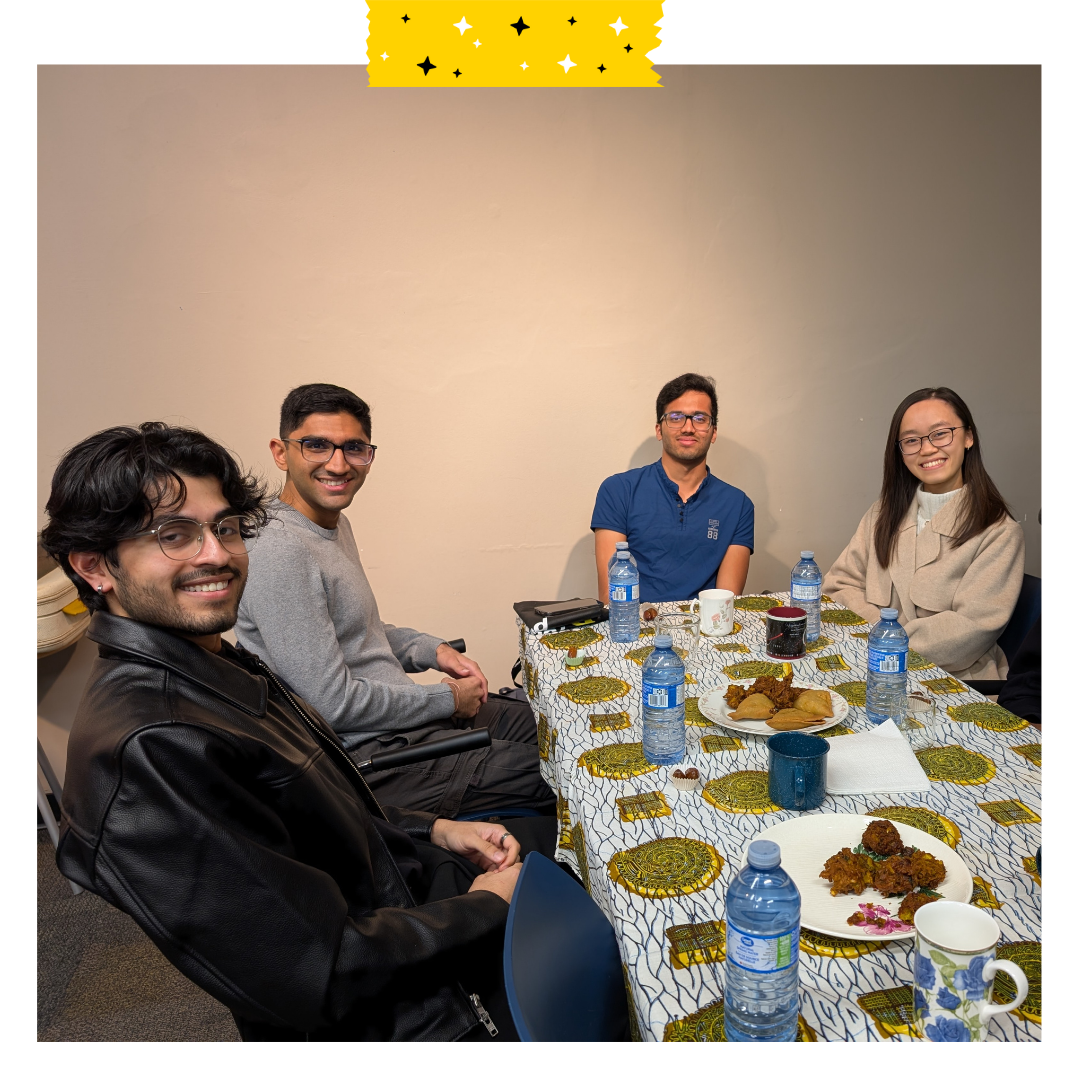 4 people sitting and eating food at a table.