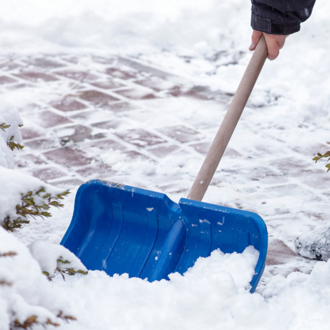Snow shovel being used on snow