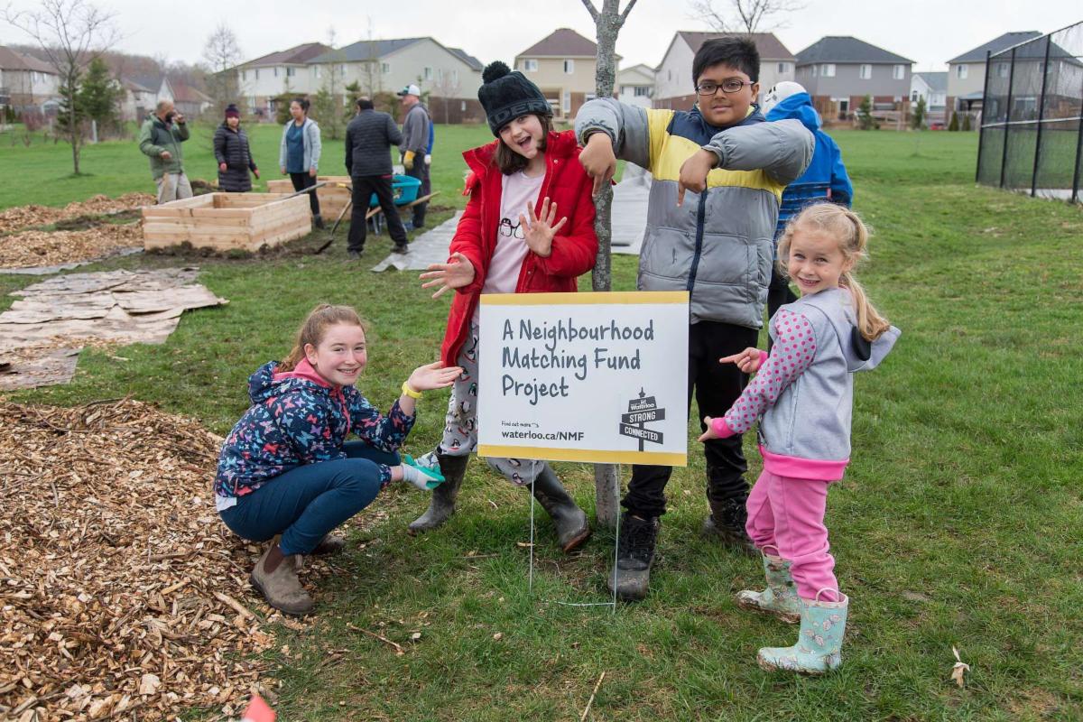 People standing around a community garden
